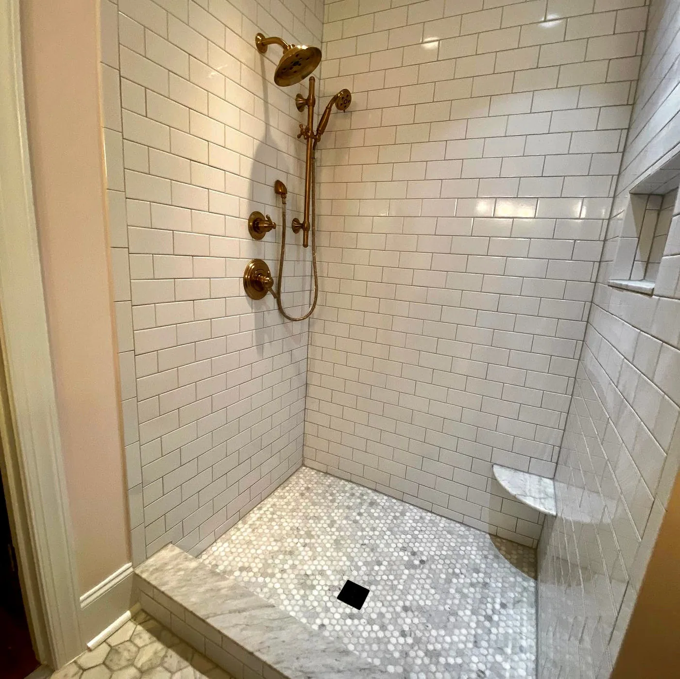 Finished bathroom renovation with detailed tile work
