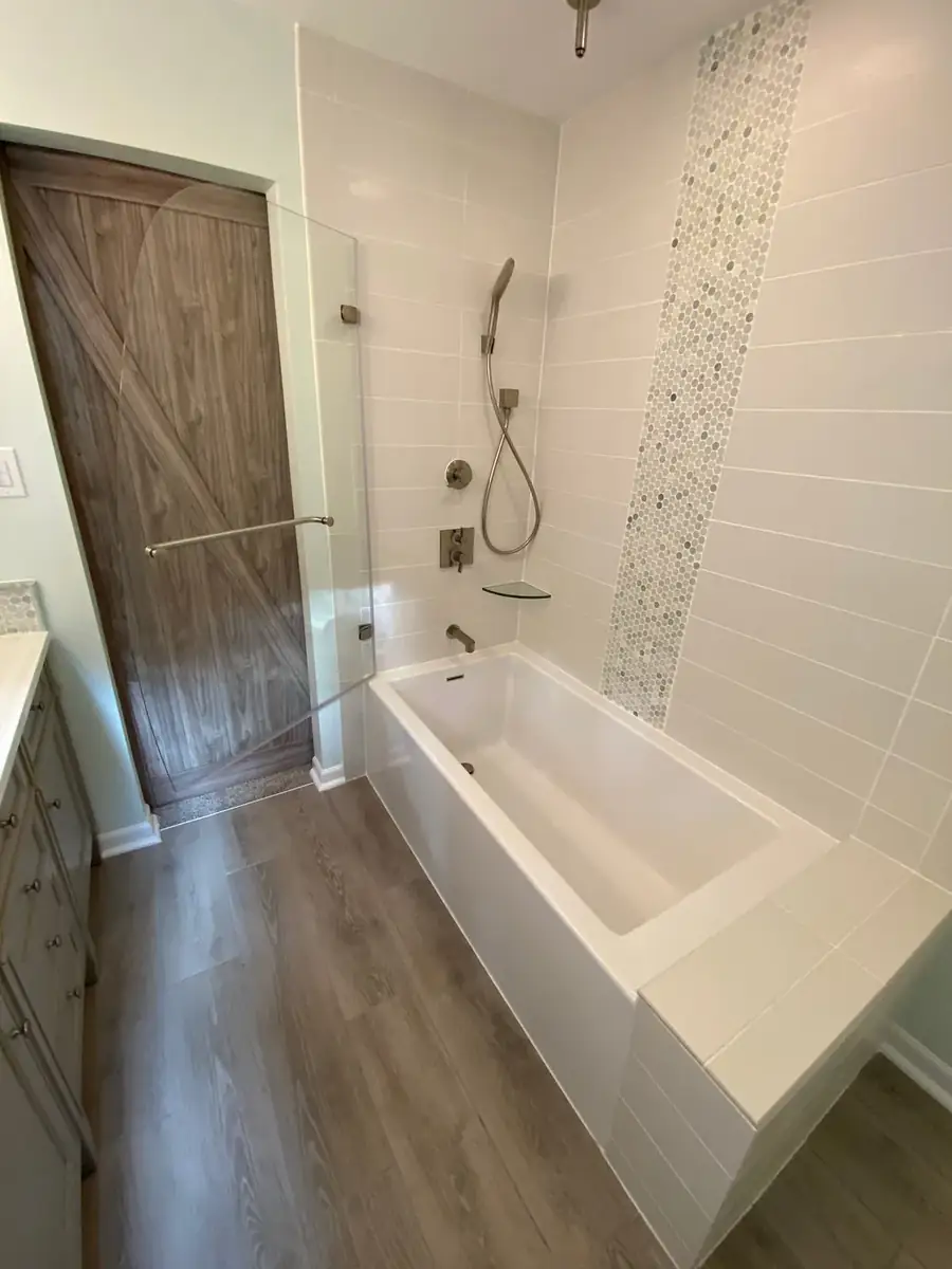Finished bathroom renovation with tub, tile and vanity