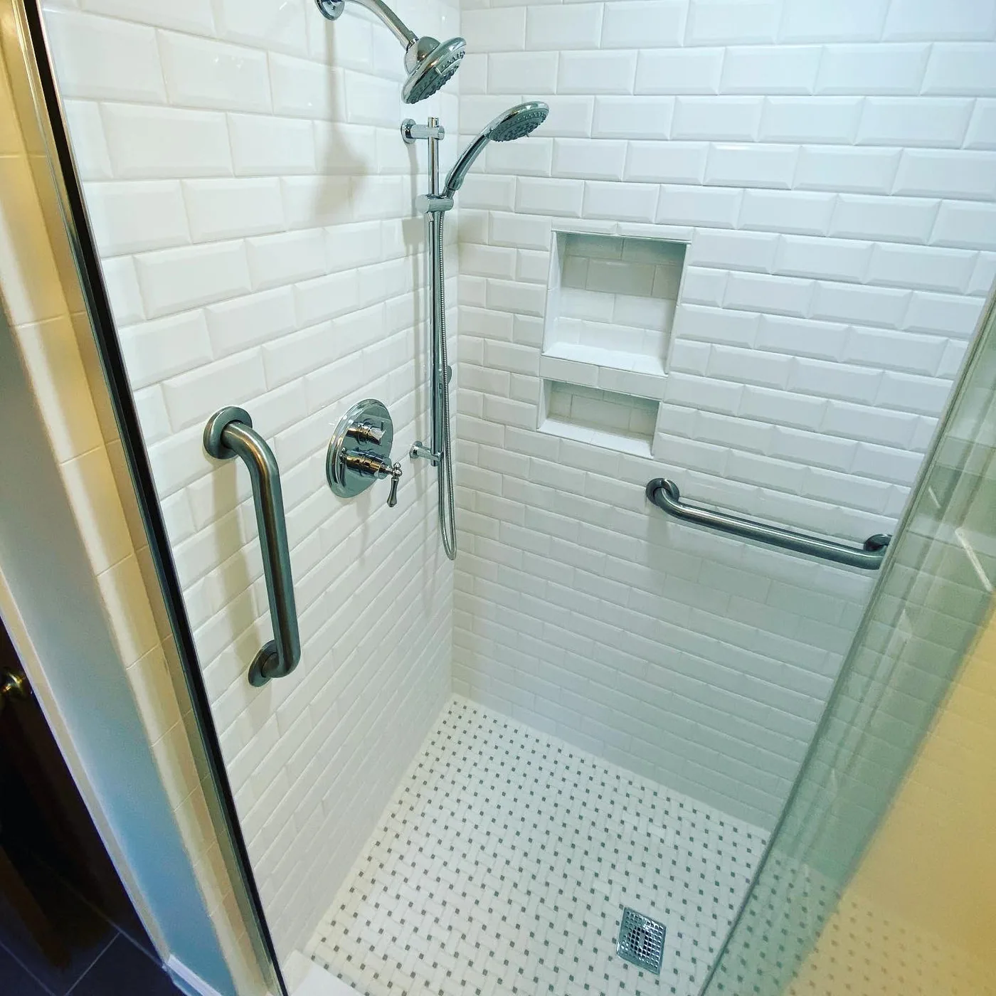 Finished bathroom renovation with detailed tile and fixtures by Betts Designs