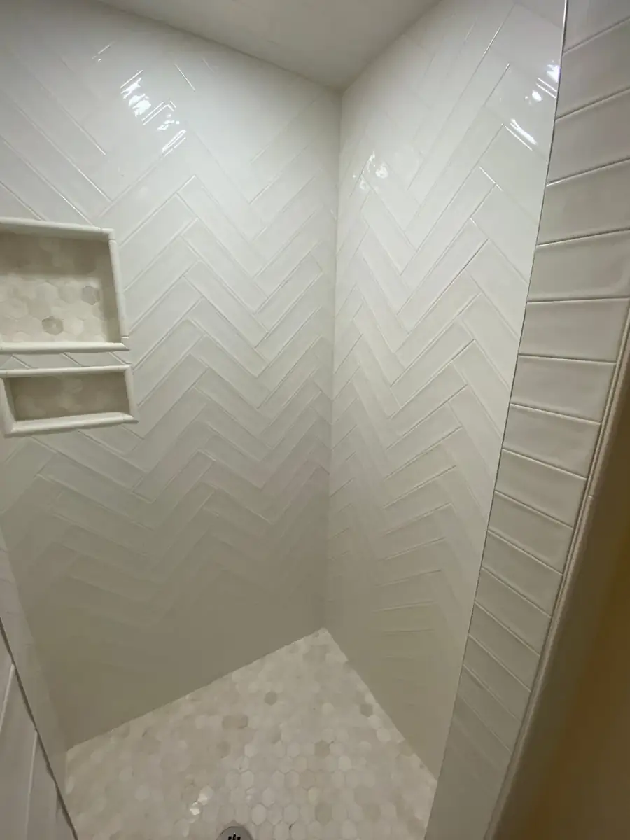 Close view of herringbone tile inside a custom shower