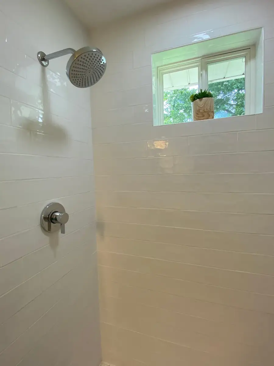 Bright tiled shower with a window for natural light