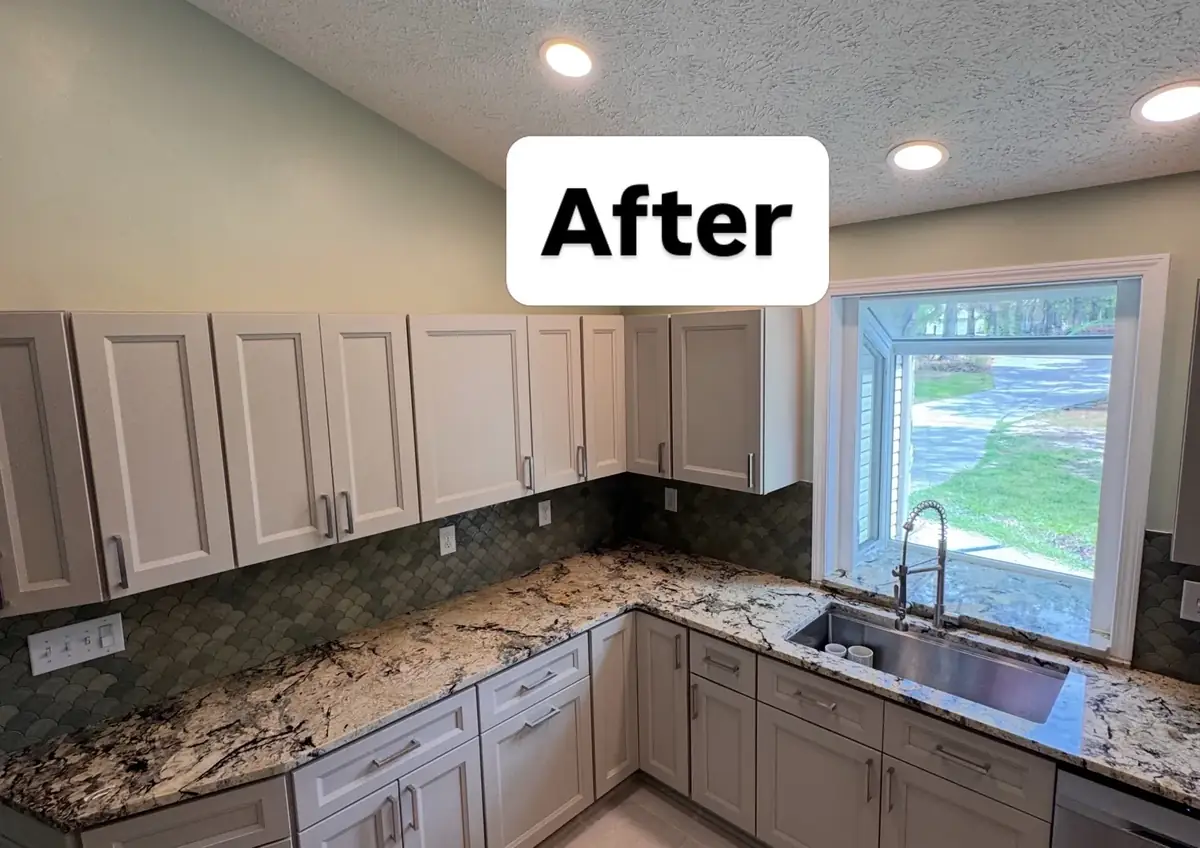 Finished kitchen with light cabinetry, granite countertop, sink and scallop tile backsplash